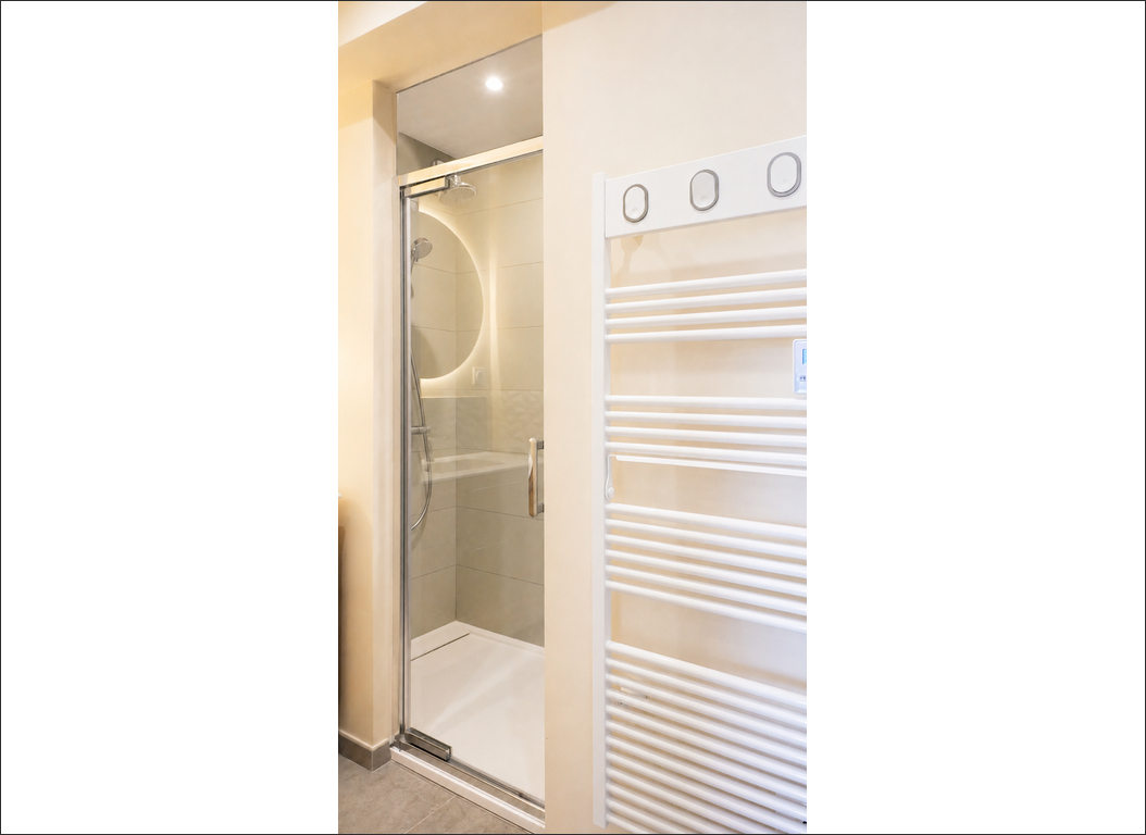 douche vitrée et sèche-serviettes dans la salle de bain à Radinghem (Nord)